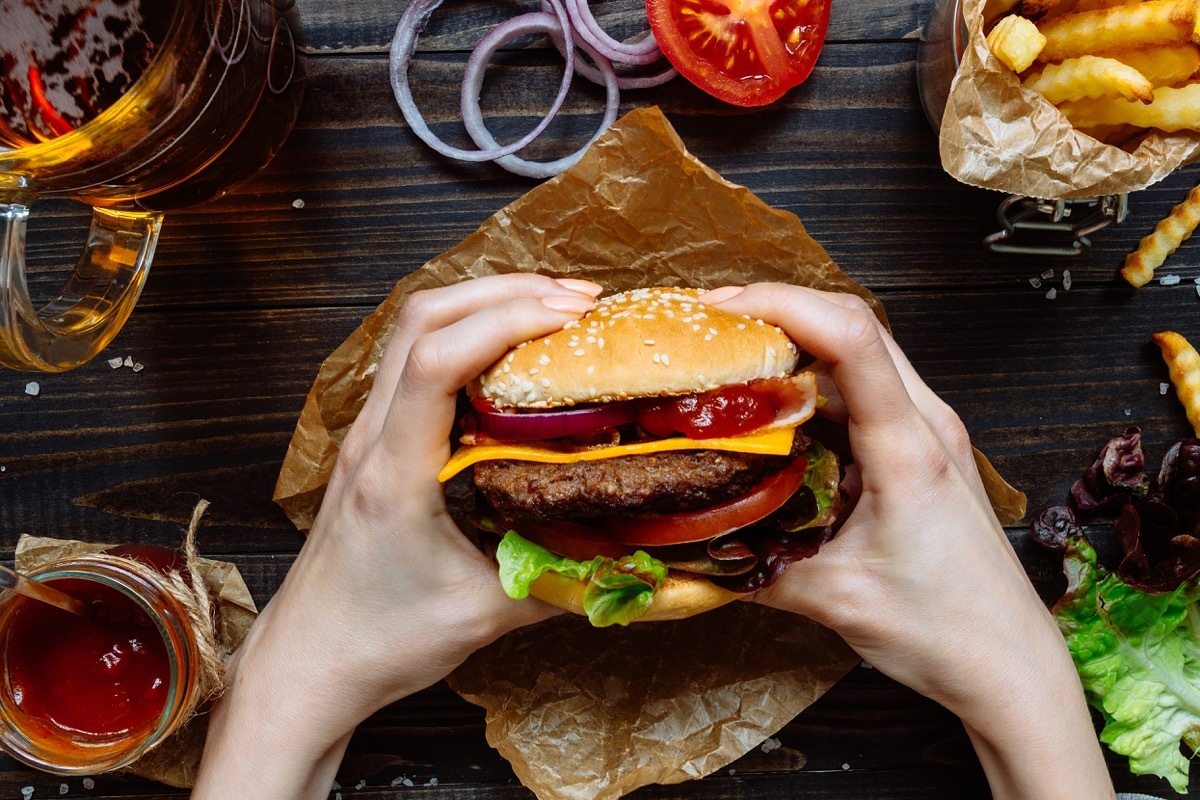 Person holding a burger