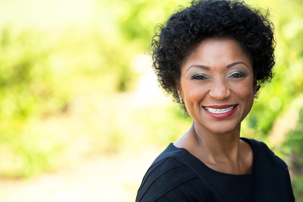 older woman smiling outside, makeup for older women