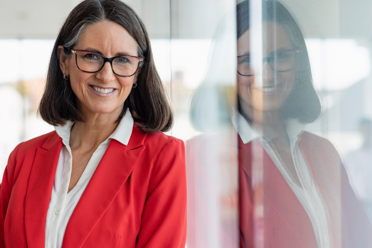 older woman in red blazer