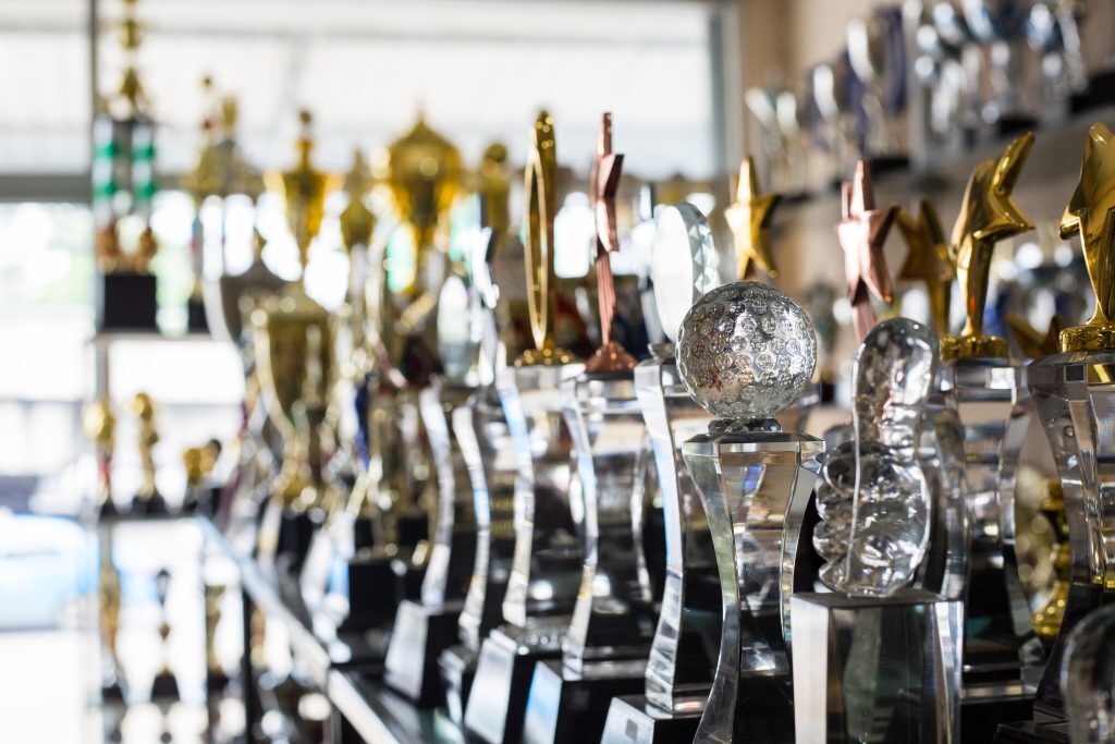 sports trophies in trophy case over 40 home - cat puns