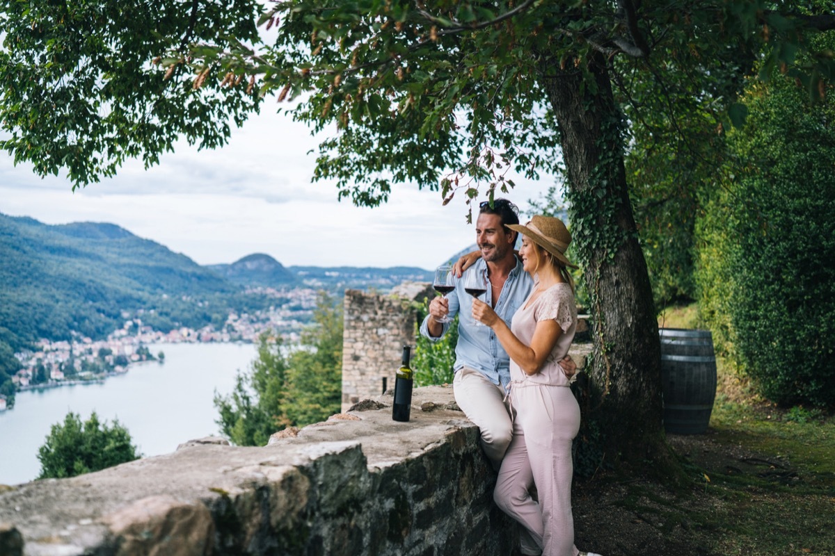 Couple enjoy some red wine in Italian vineyard