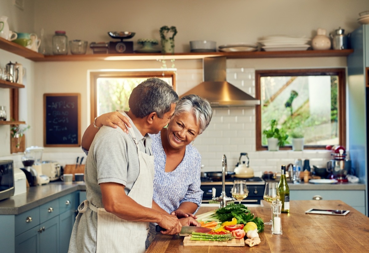 old couple cooking dinner together