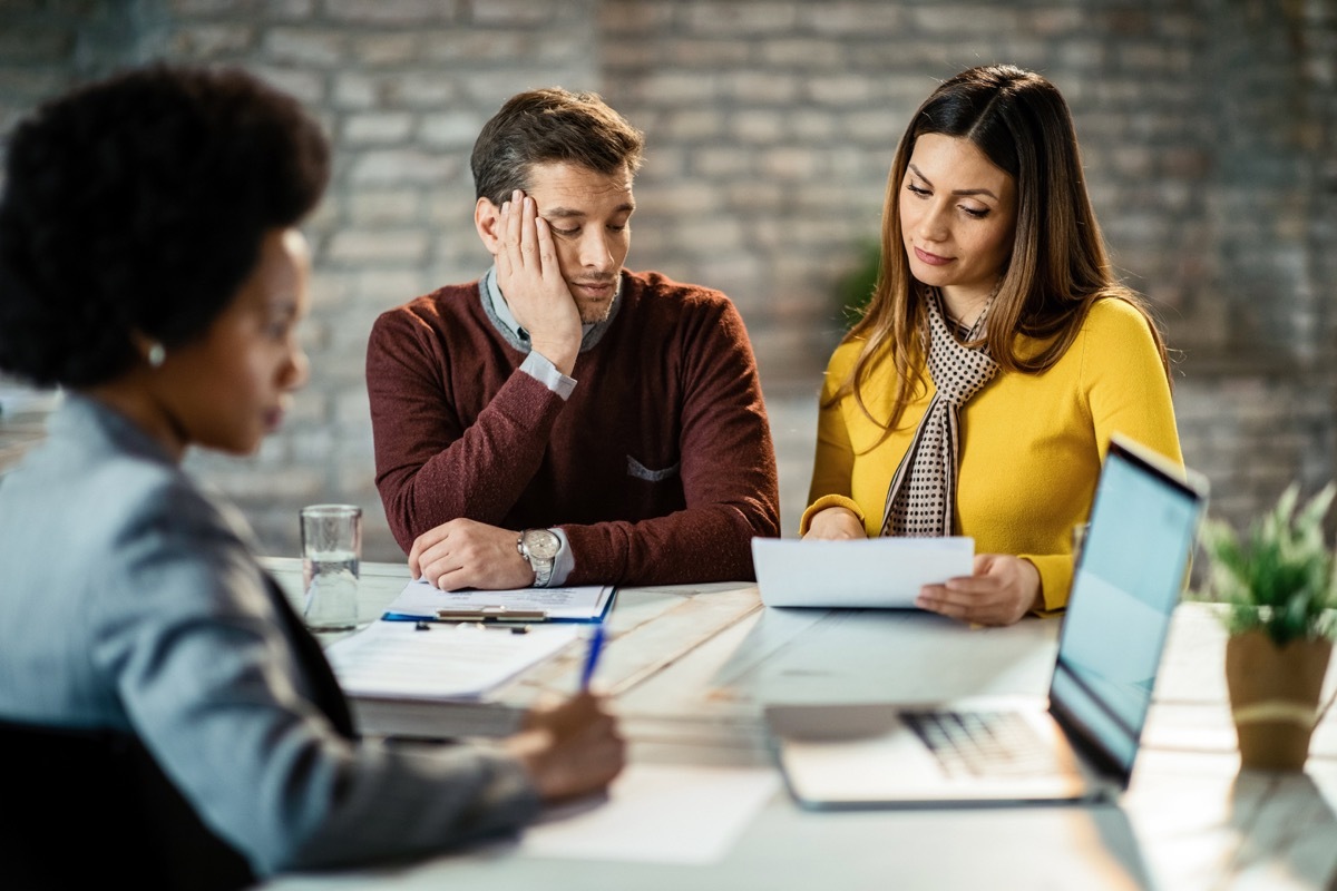 man bored about doing paperwork with his wife