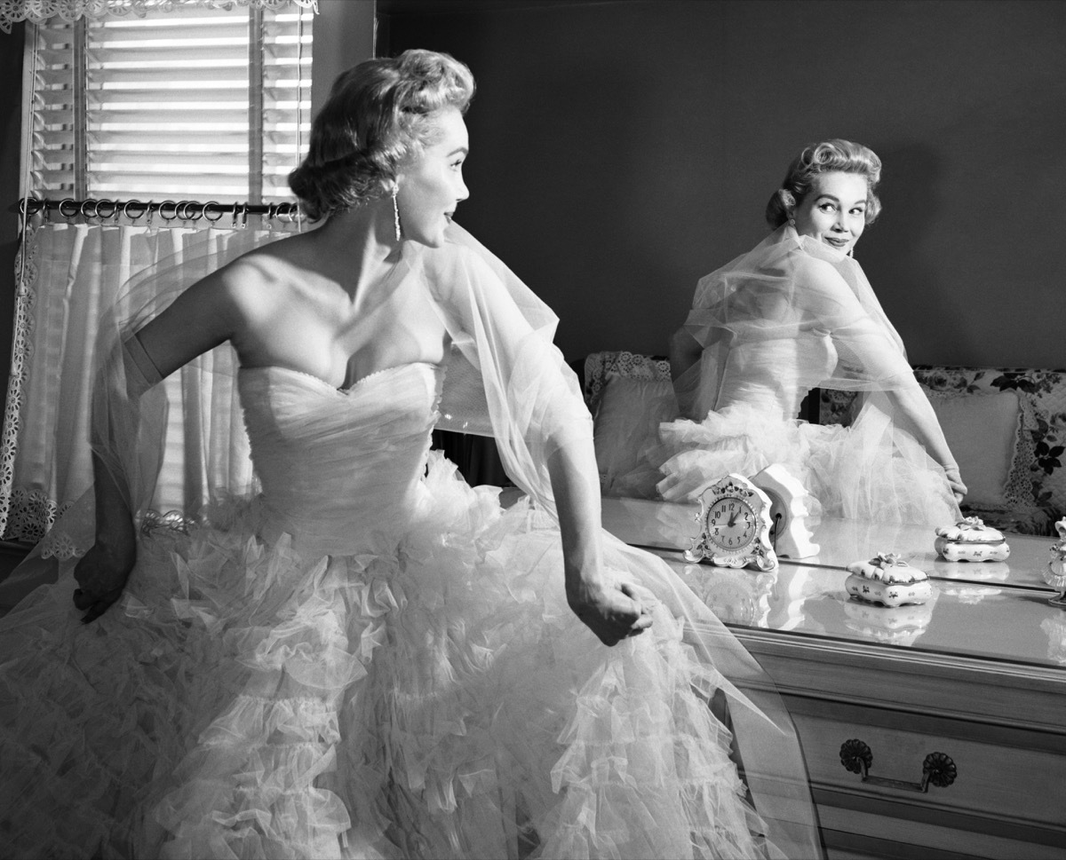 A Woman Looking in the Mirror While She Gets Ready in the 1950s