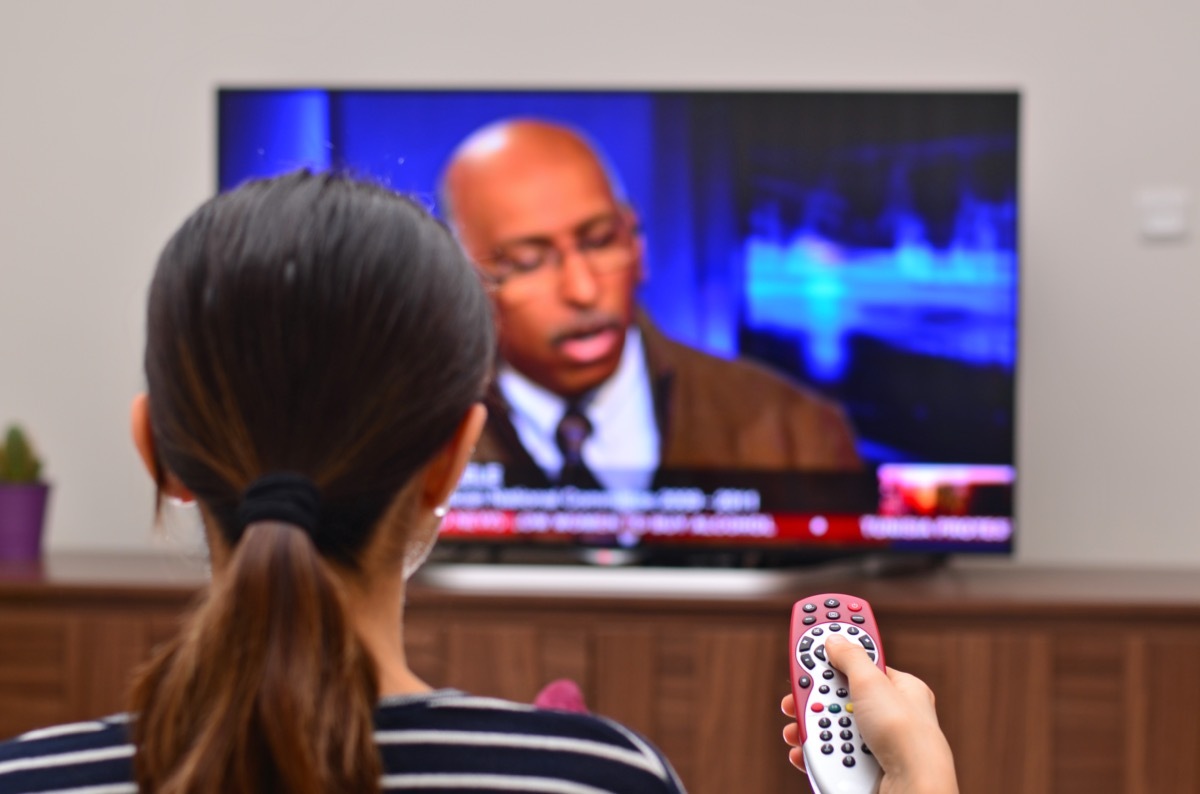 Women is watching news on a global tv channel