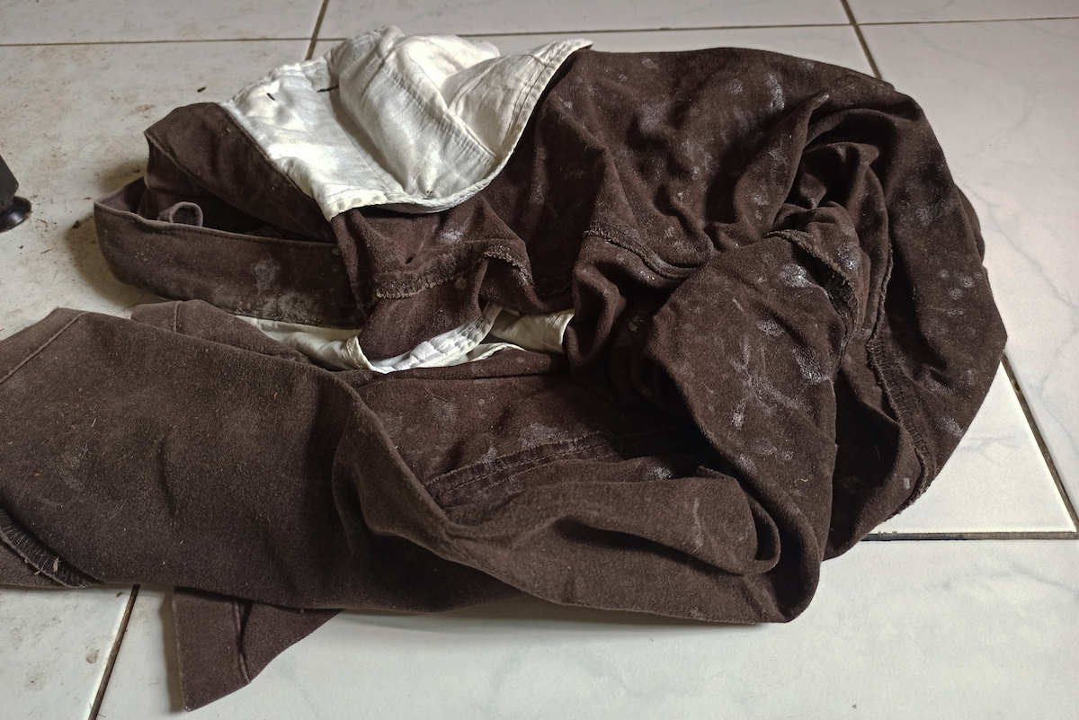 Selective focus image of dirty trousers on the floor