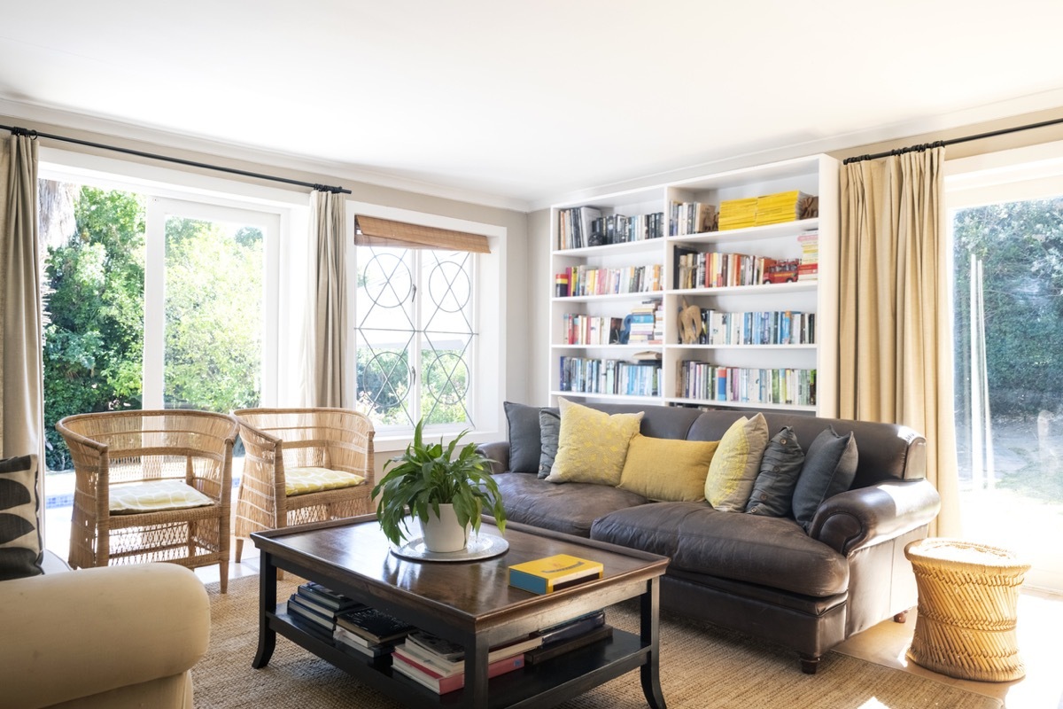 Sofa and chairs in living room. Interior of simple home. Furniture is arranged in sitting area.