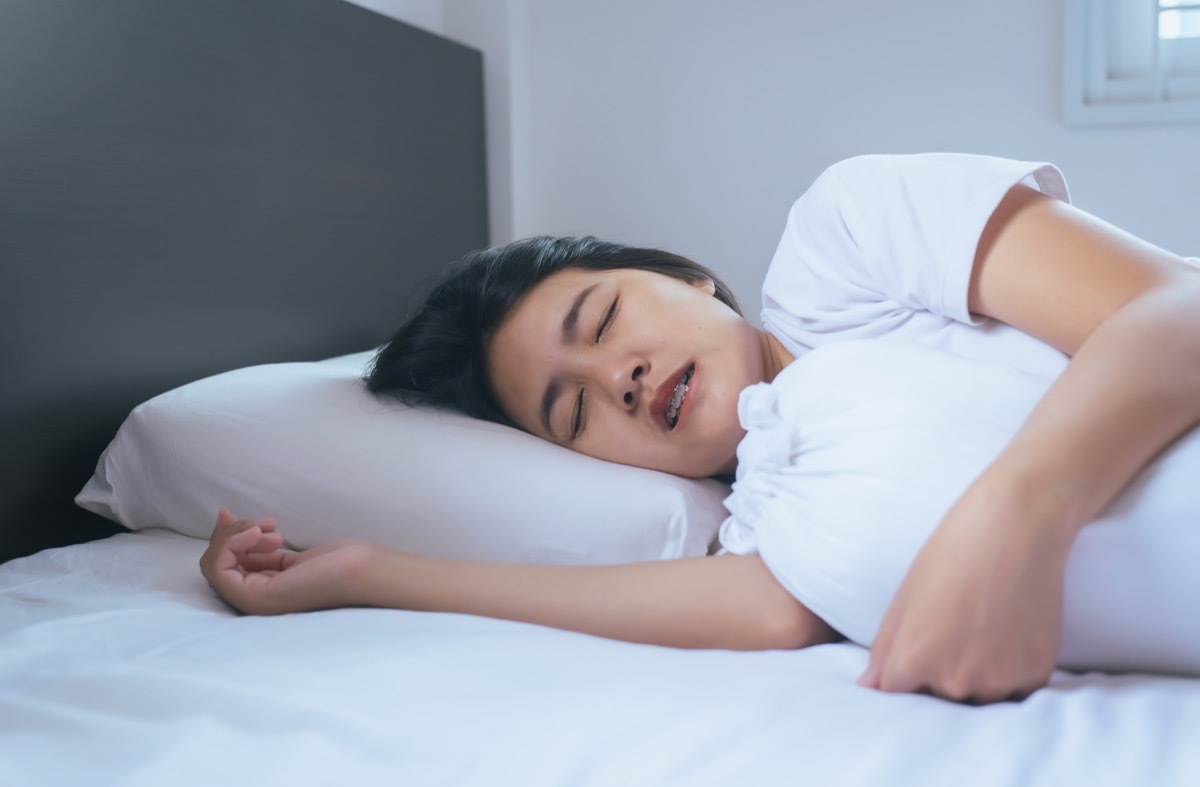 woman grinding teeth in bed