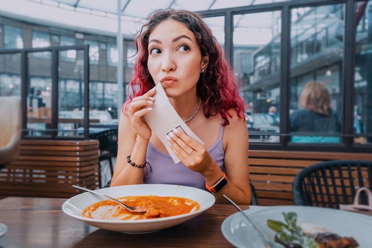 Girl Wiping Her Mouth with a Napkin