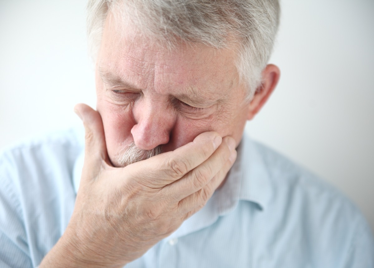 Older Man with Hand Over his Mouth Because of Nausea Surprising Symptoms