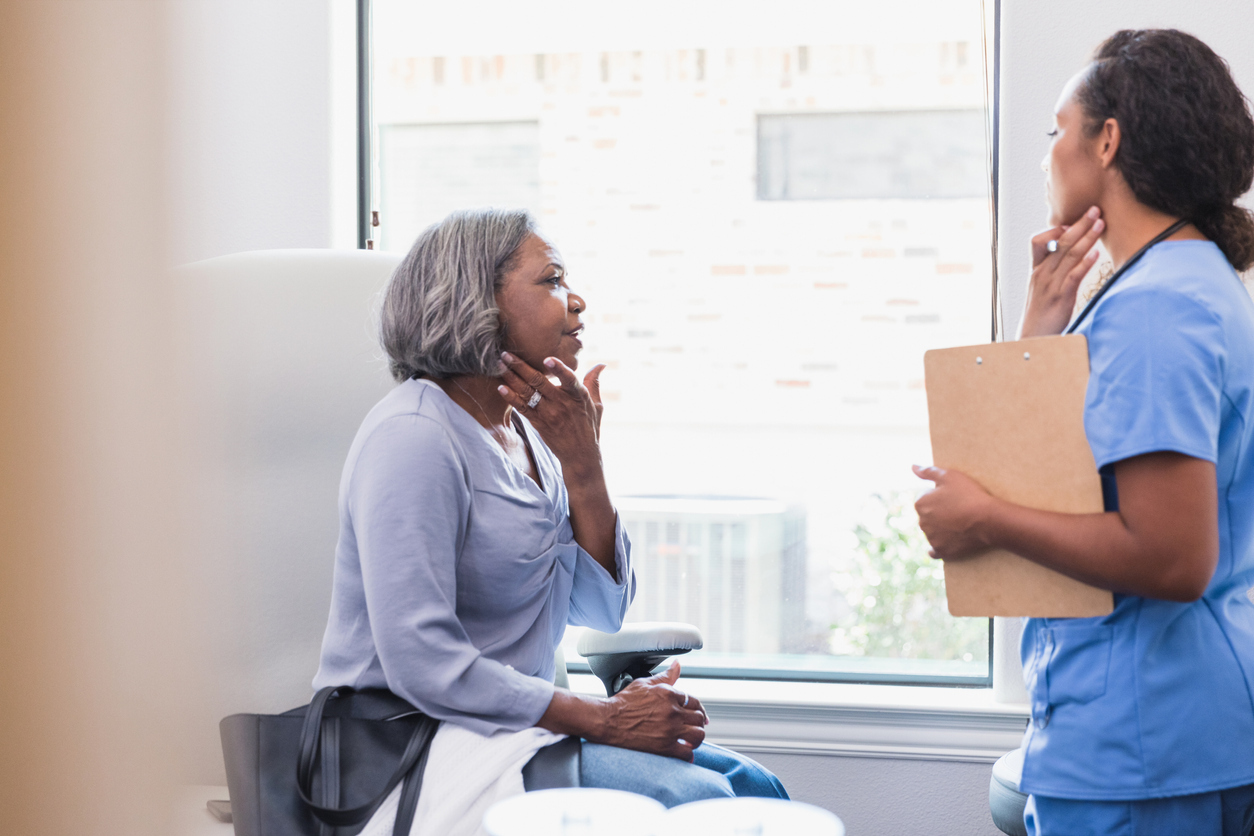 Woman talking about a skin rash with her doctor.