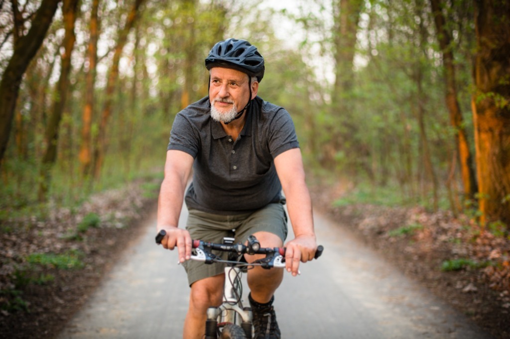 older man riding his bike in the morning outdoors