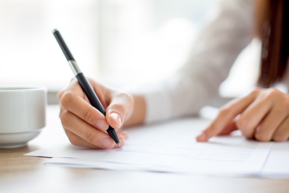 Woman writing things with a pen