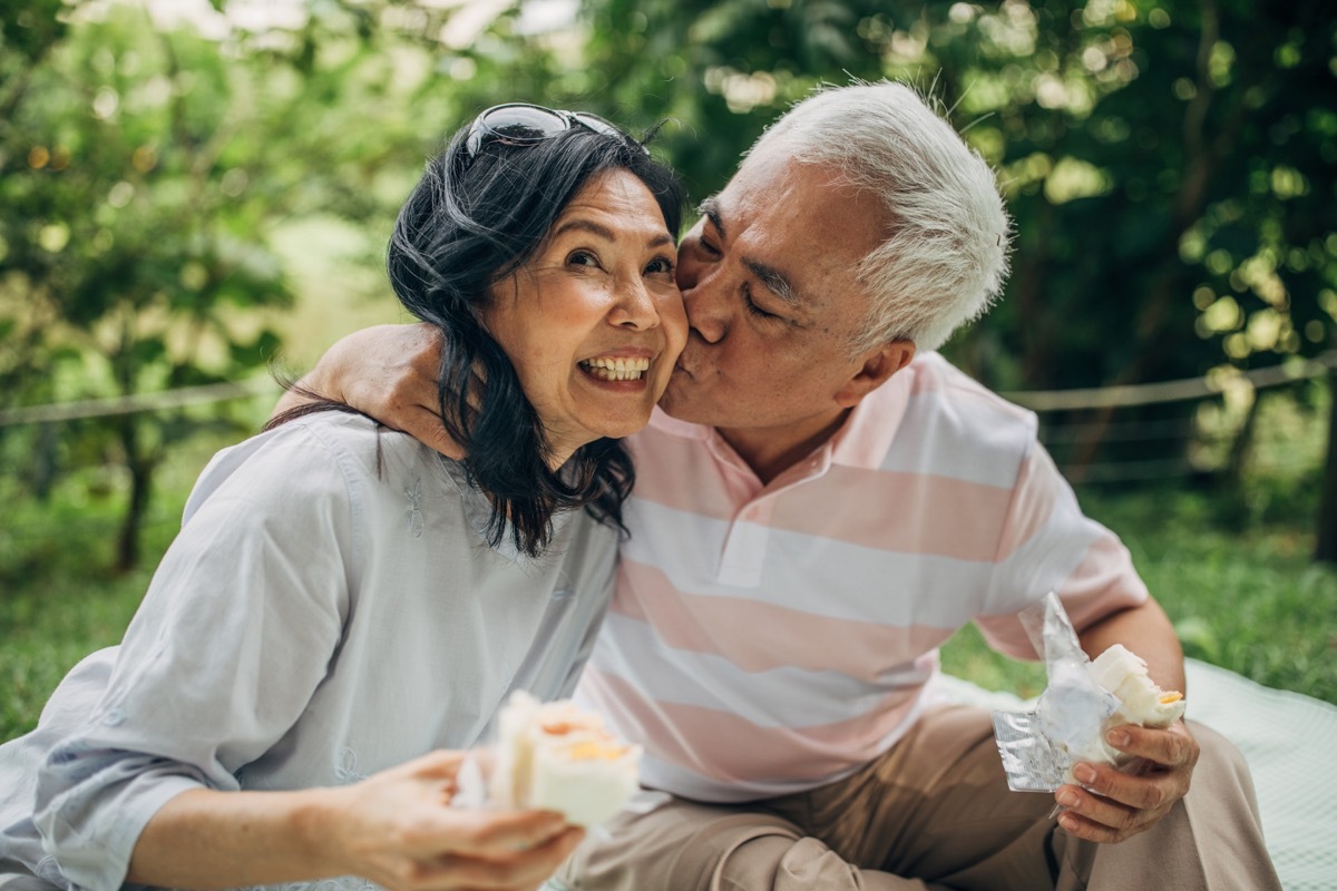 older asian couple kissing