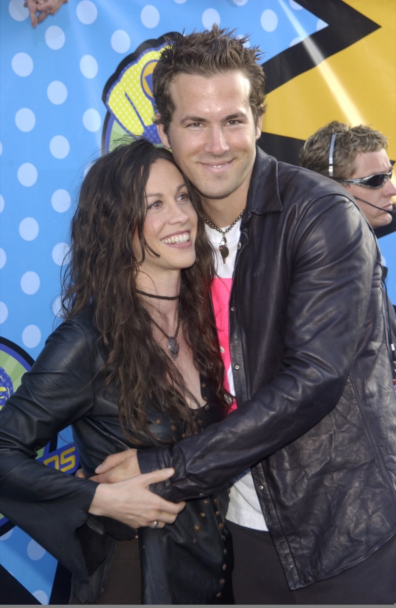 Alanis Morissette wears a black jacket and Ryan Reynolds wears a black jacket at the MTV Movie Awards in 2003