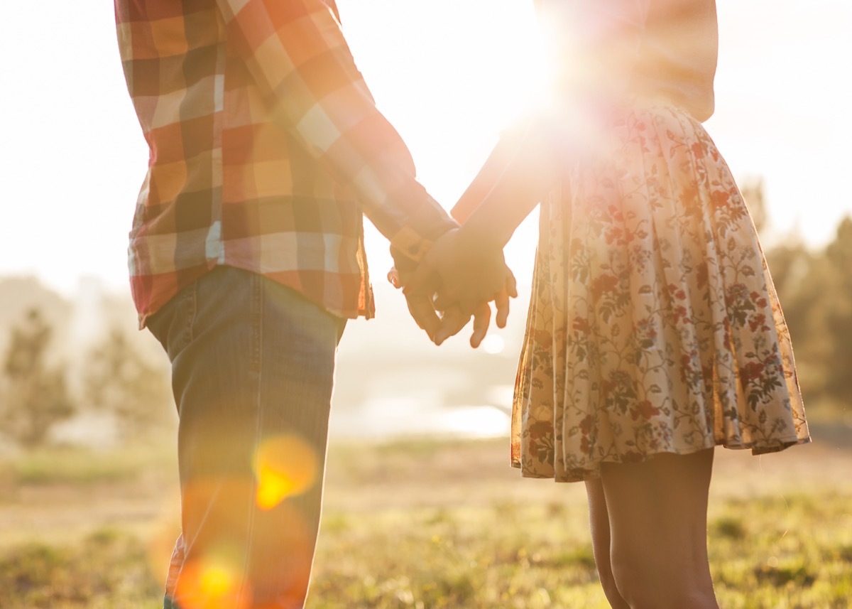 couple holding hands in a park