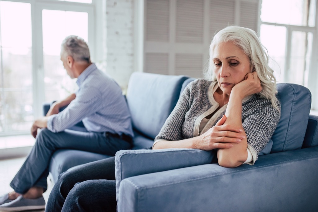 Older couple having an argument and fighting on the couch, better wife after 40