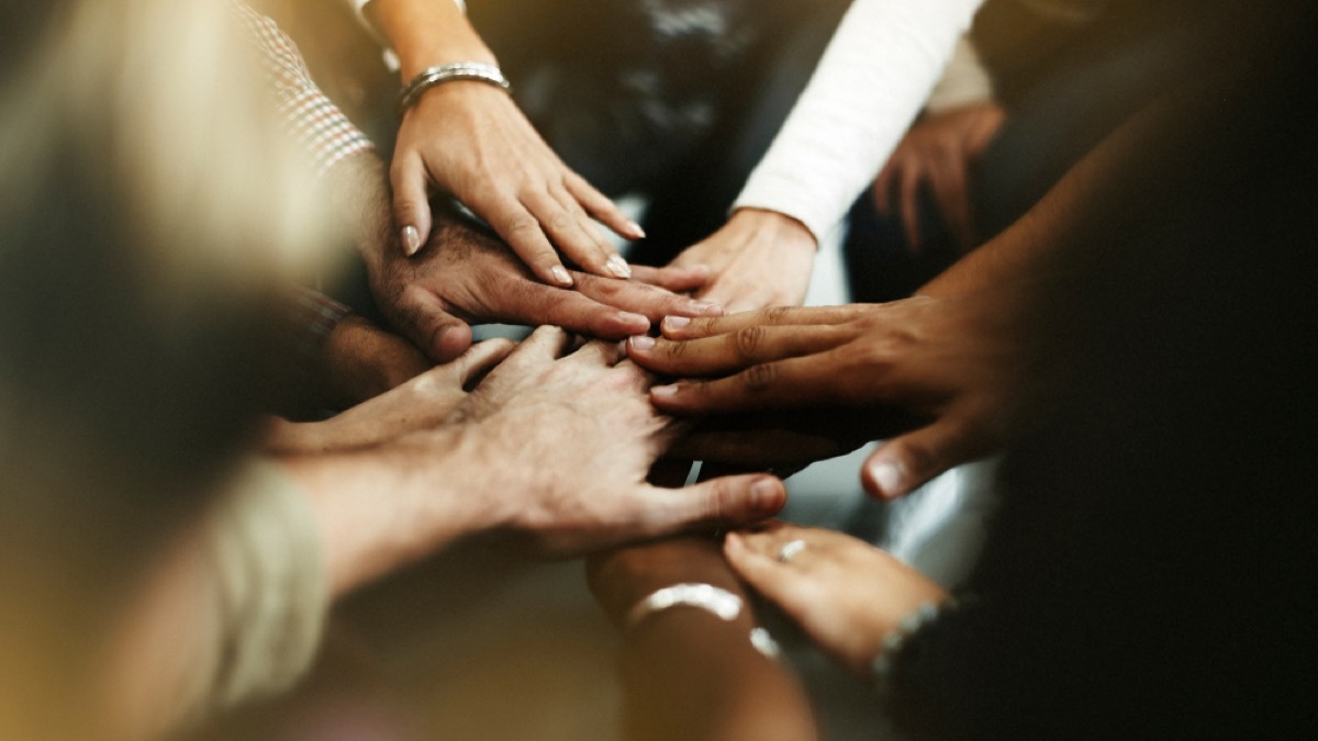 diverse hands in huddle