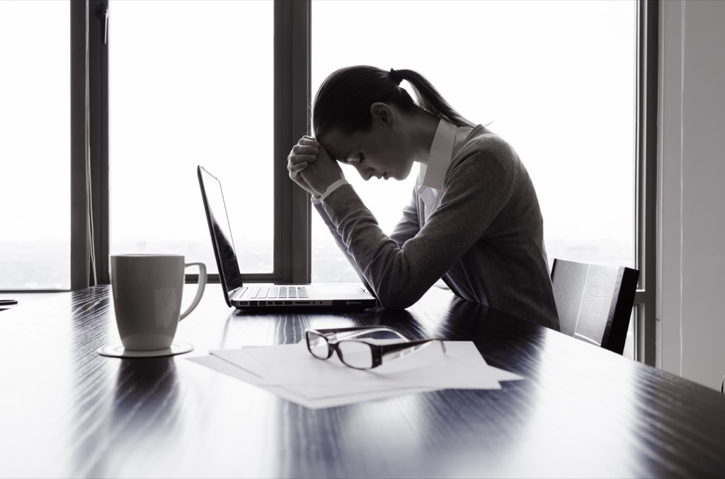 stressed out woman at a desk feeling guilty