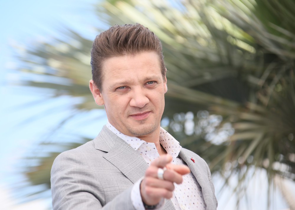 Jeremy Renner at Cannes Film Festival pointing at someone out of frame