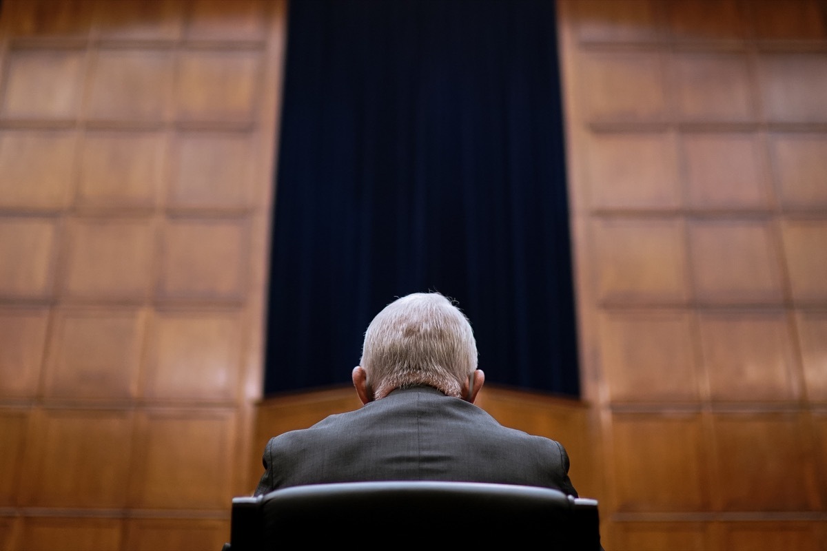 Fauci is facing away from the camera