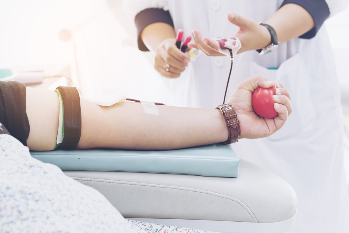 white person donating blood at blood drive