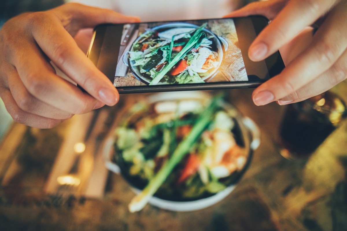 taking a picture of some food with a smart phone.