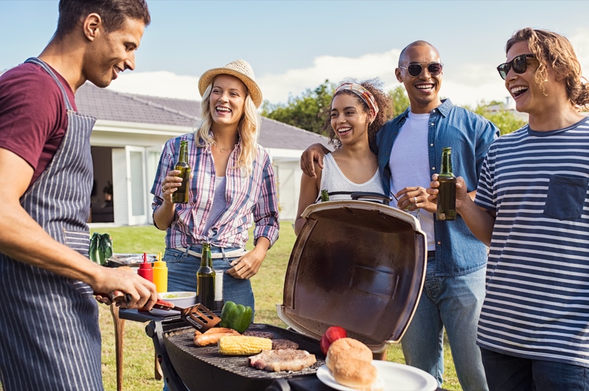 Friends Hanging Out by the Grill at a Barbecue BBQ Etiquette Mistakes