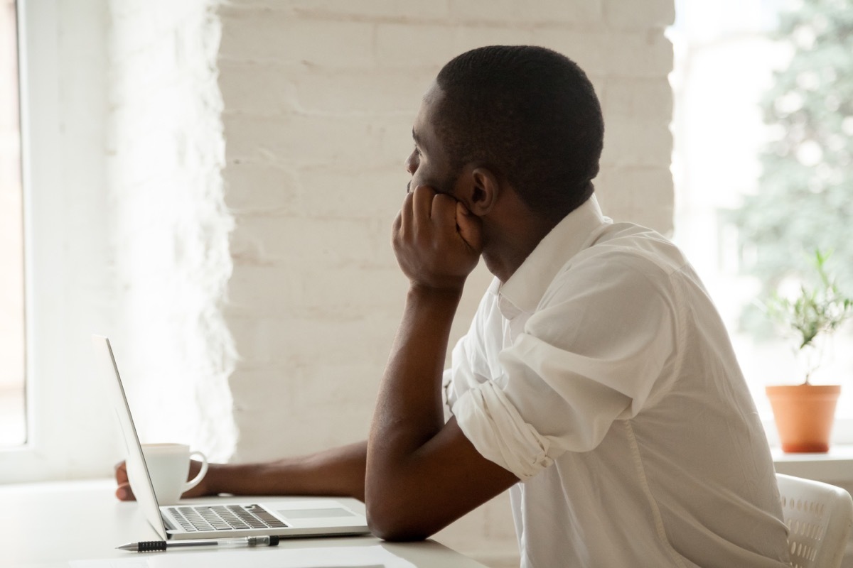 Man at work is distracted and looking out the window