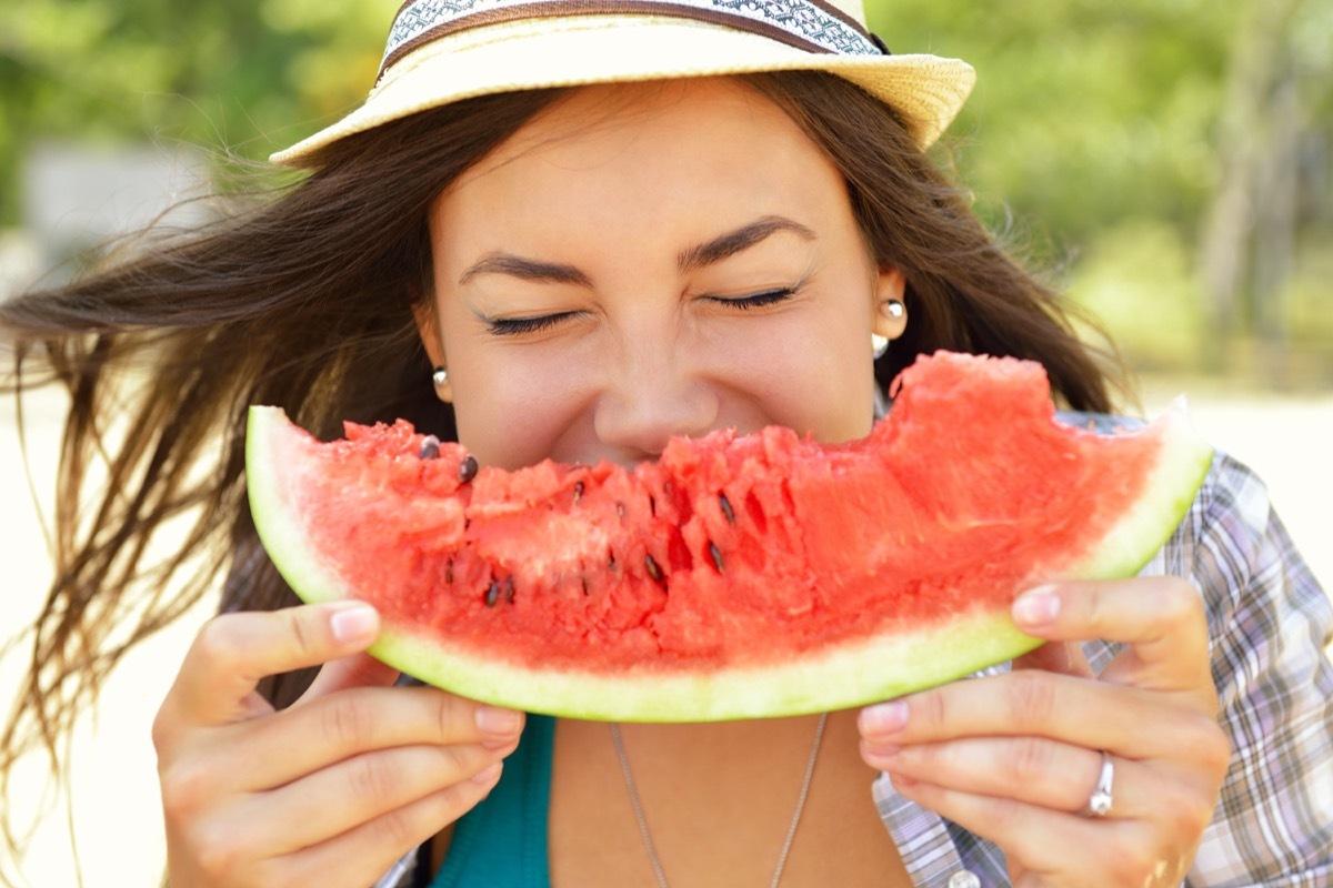 woman eating watermelon, watermelon seeds outside