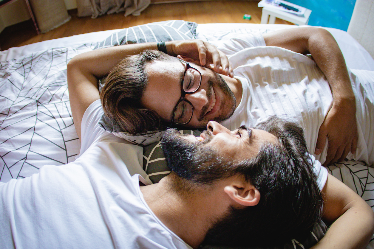 gay men lying in the bed