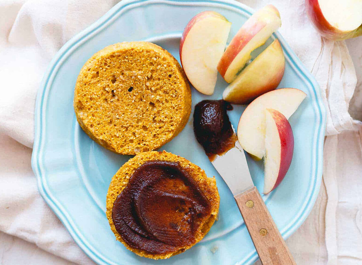 paleo pumpkin english muffins with apple butter and sliced apples on blue plate