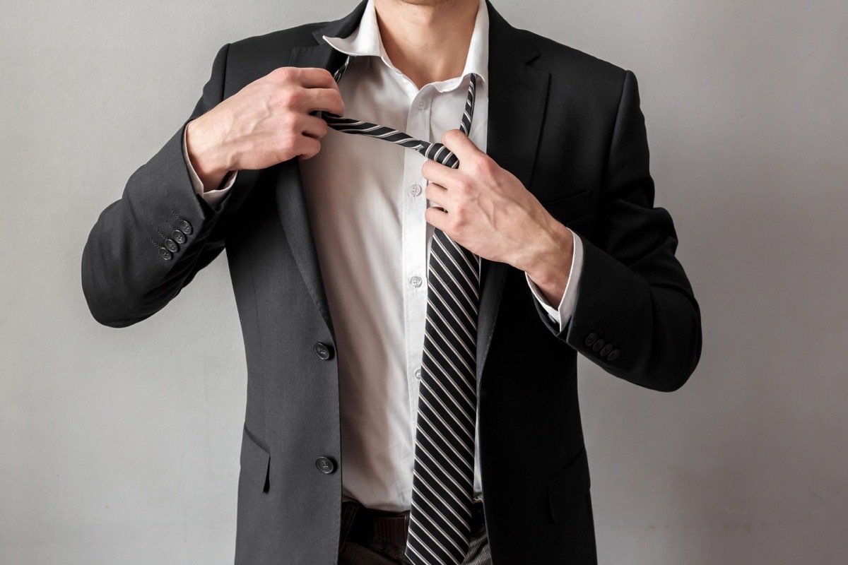 man retying a striped tie