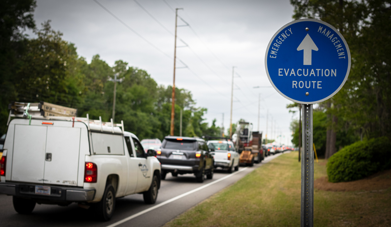 A row of cars leaving town on a hurricane evacuation route