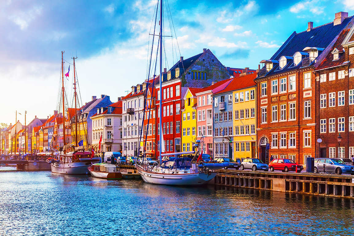 colorful buildings and sailboats on a wharf