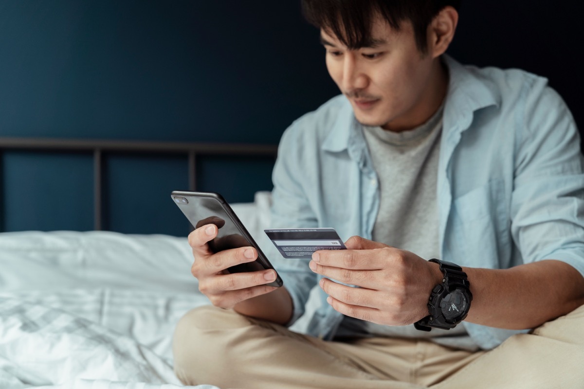 man looking at credit card statement on phone