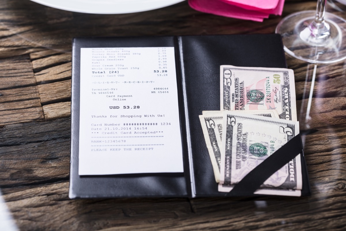 Elevated View Of Bill And Banknote On Wooden Desk