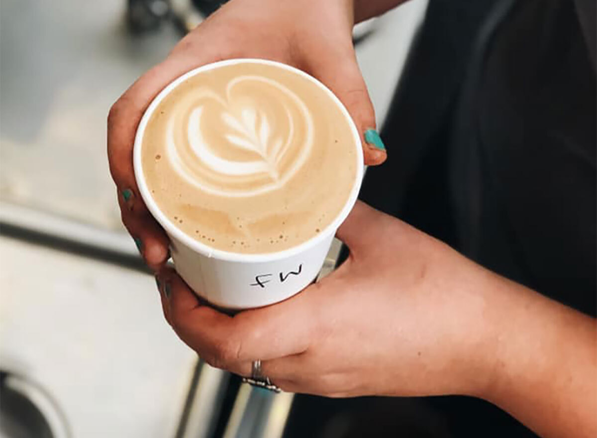 latte closeup in woman's hands