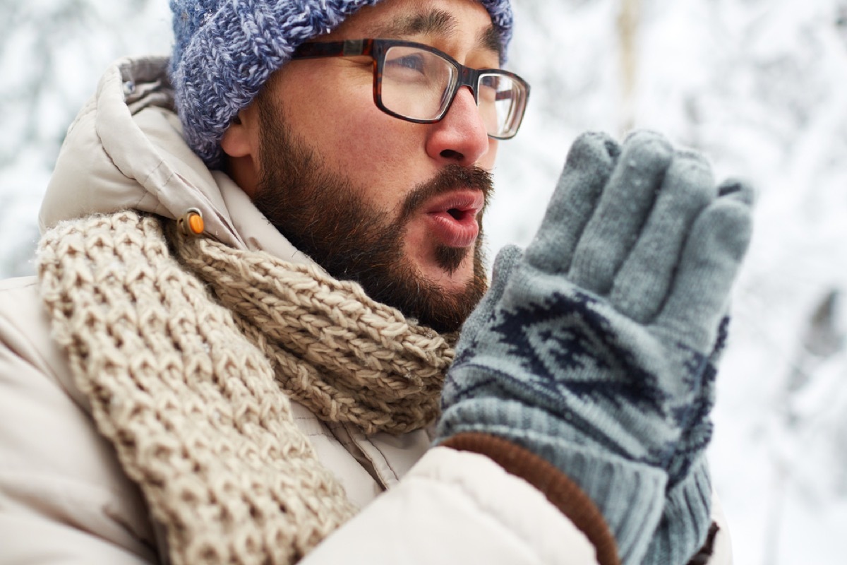 asian man outside in snow in winter clothing