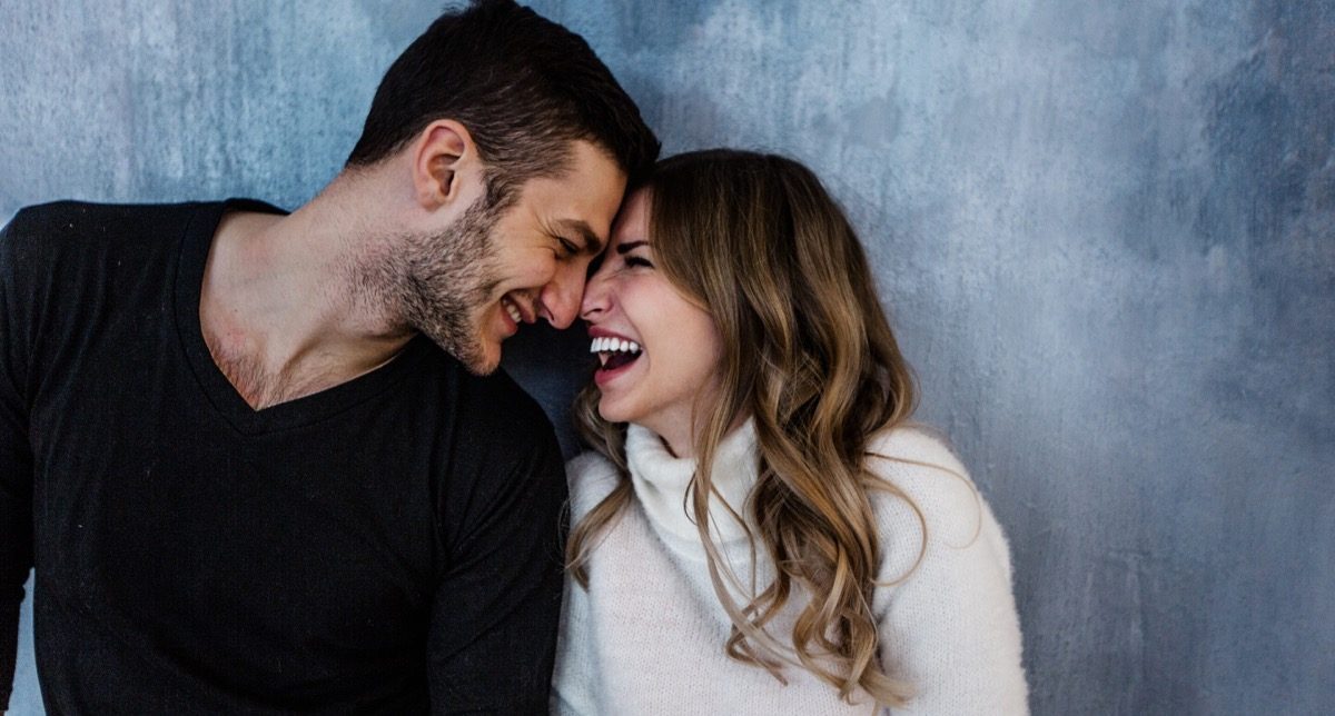 man smiling as his girlfriend expresses love messages for him