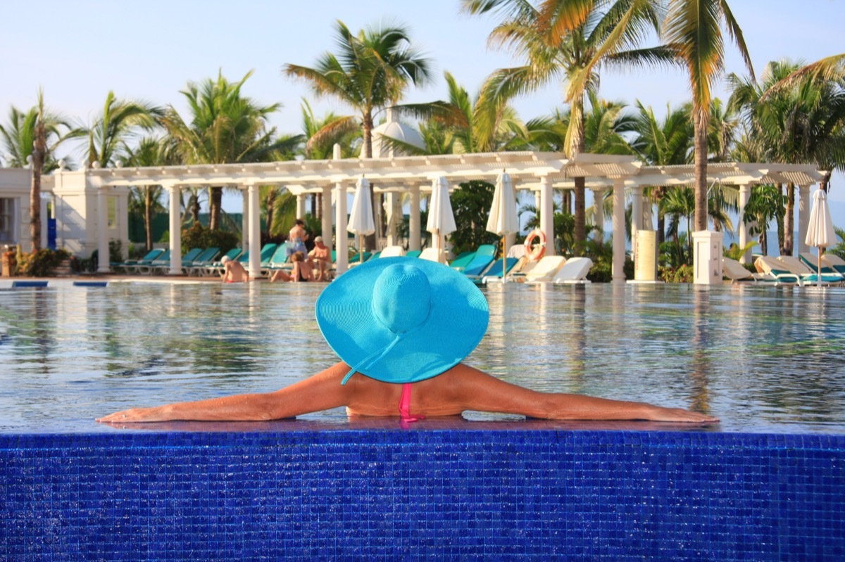 woman enjoying the pool at a resort