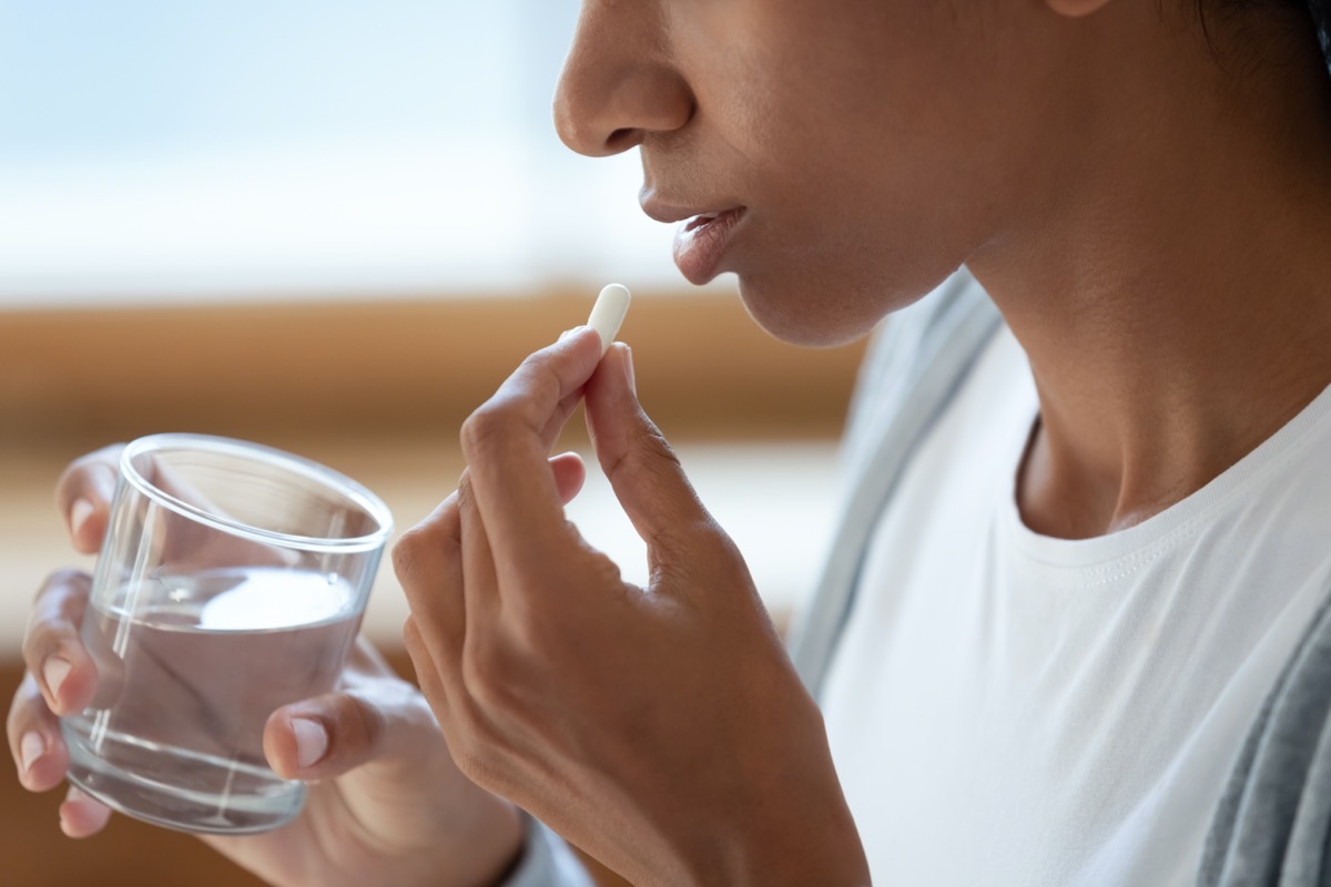 young woman taking supplement