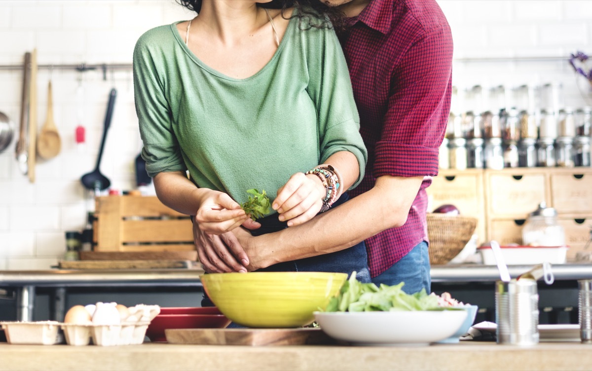 Couple cooking together in kitchen