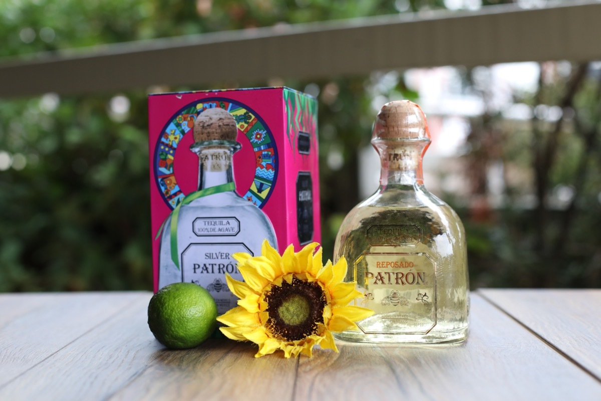 Bottle of Patron next to a flower and lime