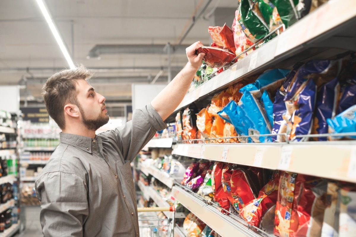 Man buying chips at the grocery store