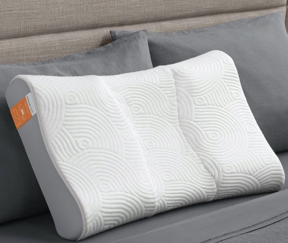 white tempurpedic pillow on gray bed