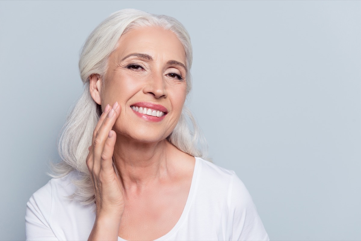 Older woman touching skin