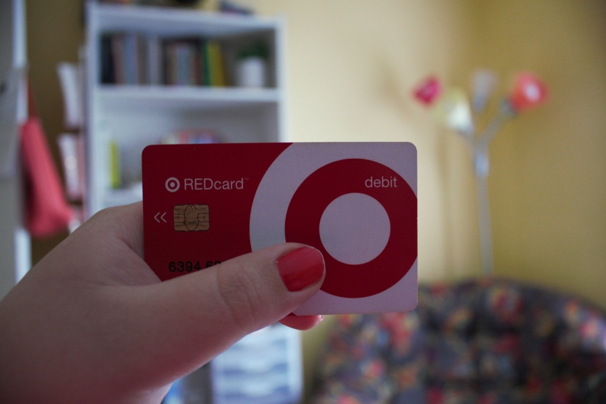 A woman holds a Target Red Card.