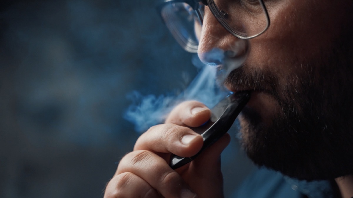 closeup of man vaping