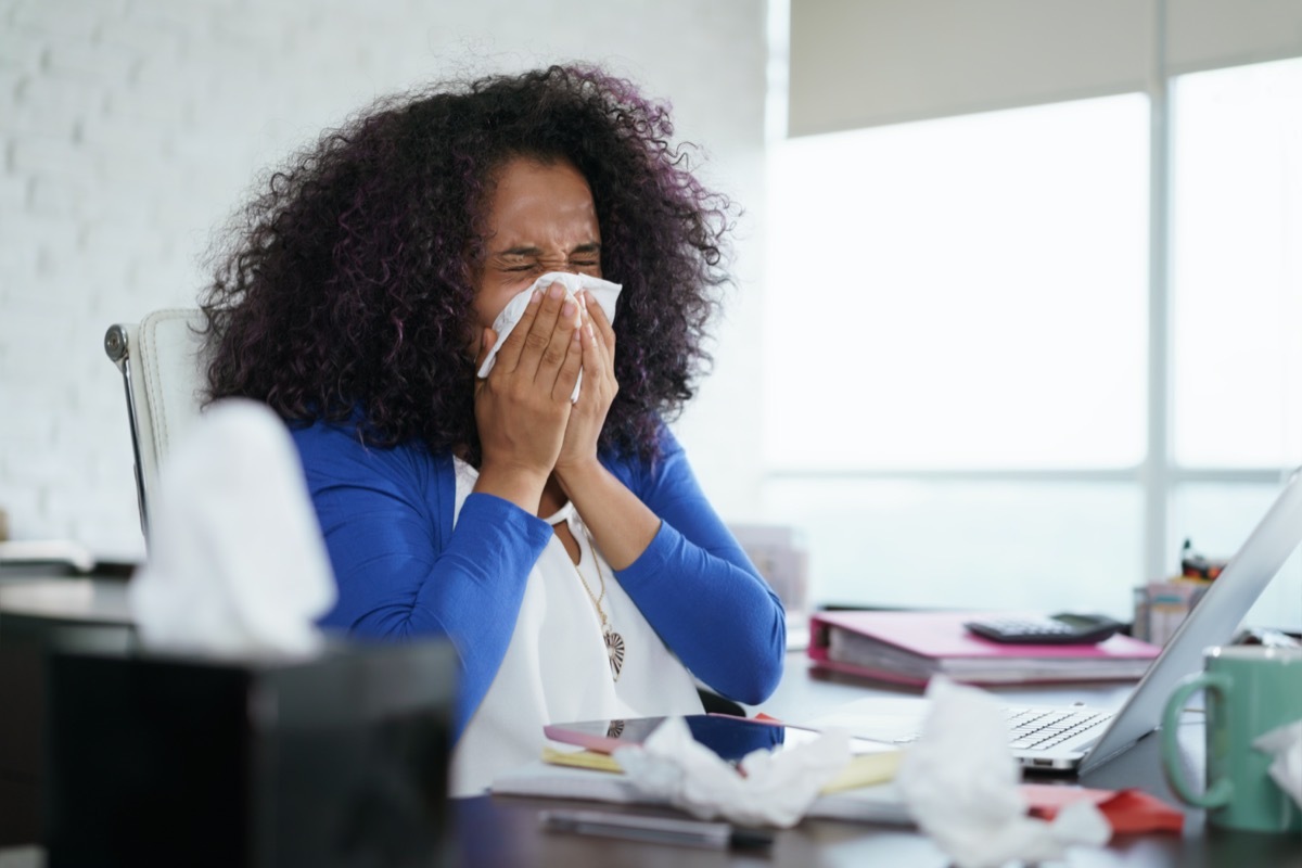 Sick woman working from home office.